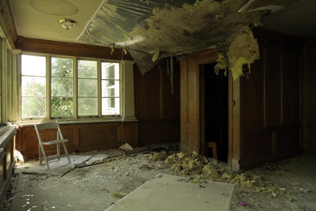 abandoned room interior with damaged ceiling