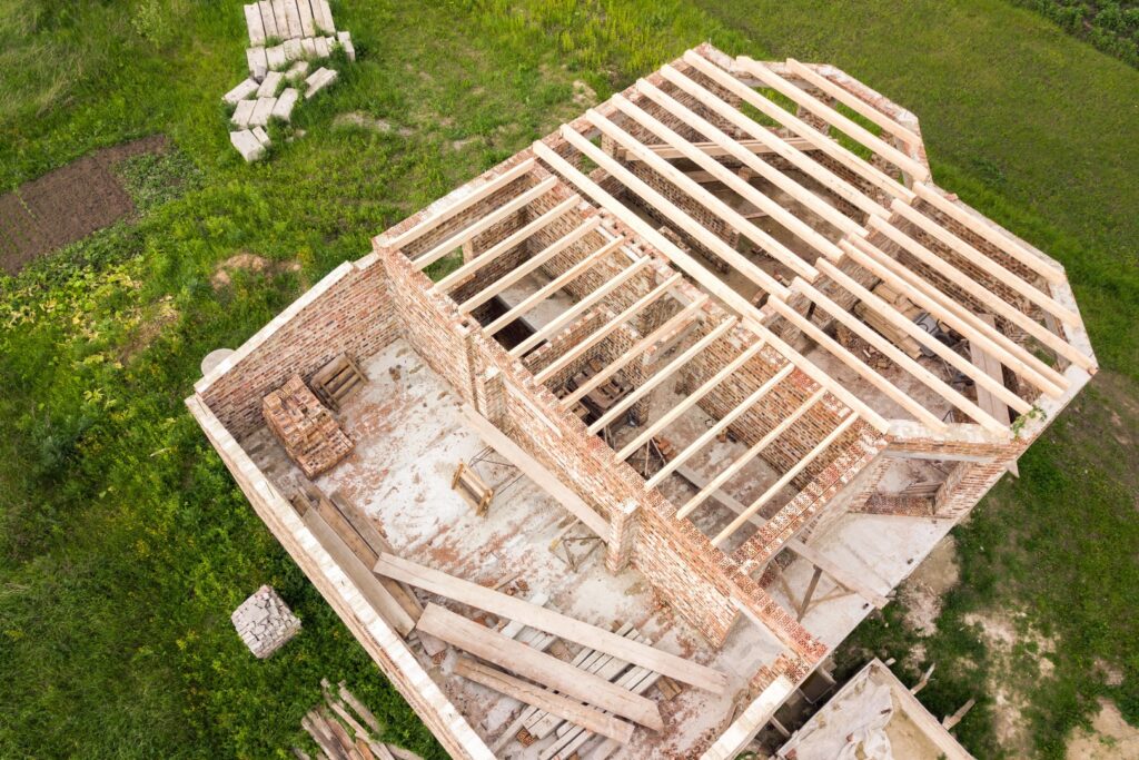 aerial view of a brick house with wooden ceiling